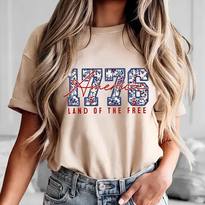 Person wearing a beige t-shirt with &