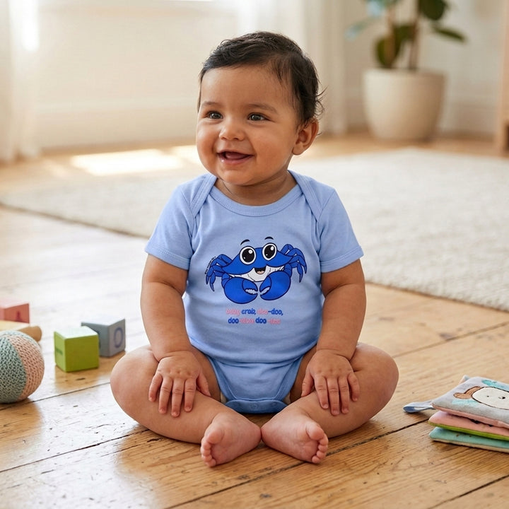 Blue baby crab onesie with the words baby crab doo-doo, doo-doo, doo-doo written under crab design. On a baby model.