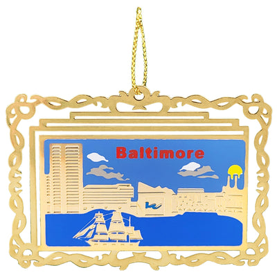 Decorative ornament with 'Baltimore' text and cityscape illustration on a golden brass frame.