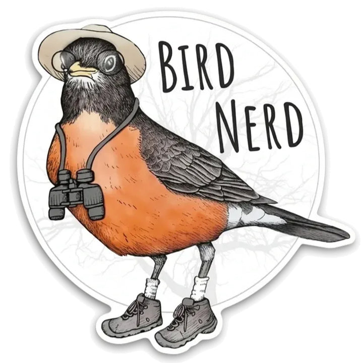 A die-cut sticker featuring a cartoon robin wearing a beige hat, black binoculars around its neck, white socks, and hiking boots, with the words “BIRD NERD” in black text on a white circular background.