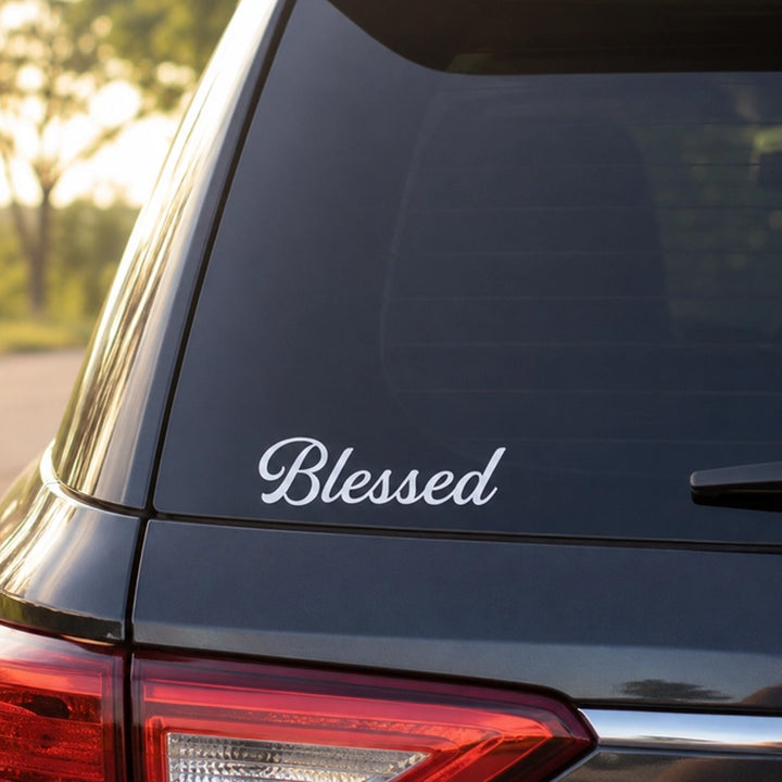 A white cursive vinyl decal reading &