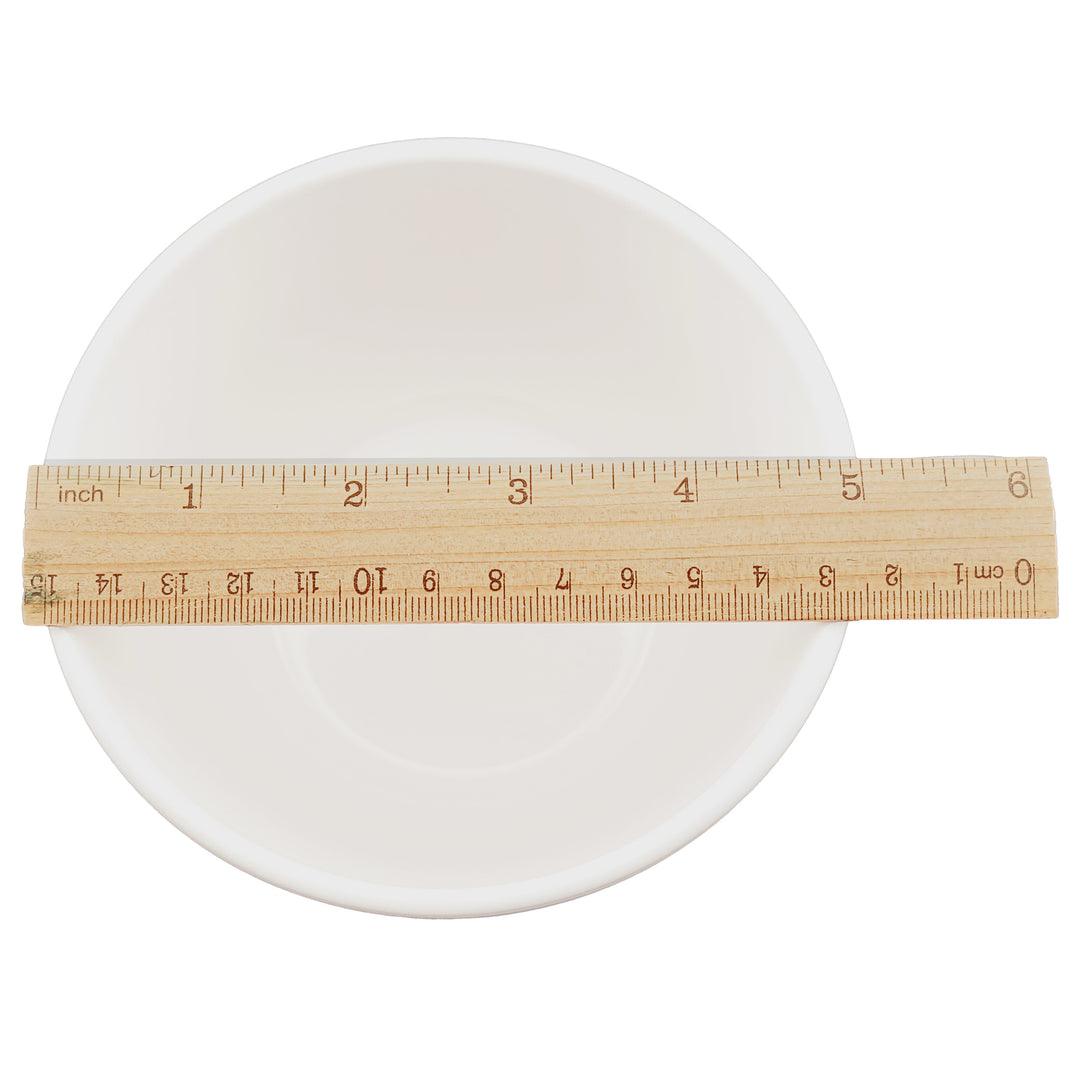 A 24oz. white ceramic soup mug shown from above with a wooden ruler laid across the front to indicate size in inches and centimeters.