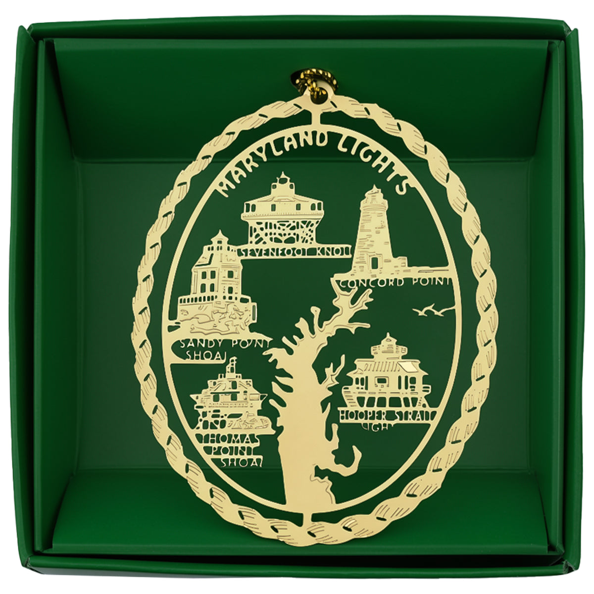 An oval-shaped rope style brass Christmas ornament featuring Maryland lighthouses and a Chesapeake Bay silhouette, presented inside a dark green gift box.