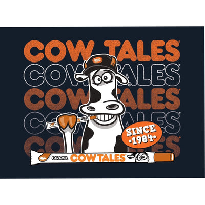 Cow Tales candy magnet with a cow illustration and text on a dark background