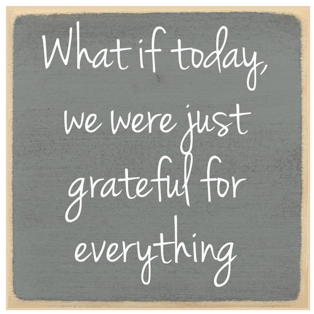 Gray wooden sign with white text &