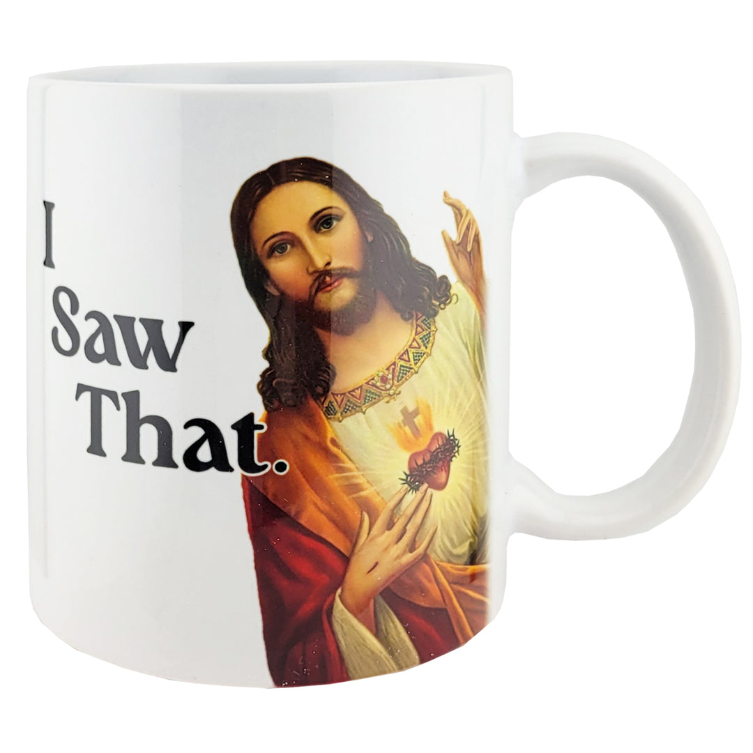 A white ceramic mug featuring a printed graphic of Jesus with a glowing sacred heart and the text &