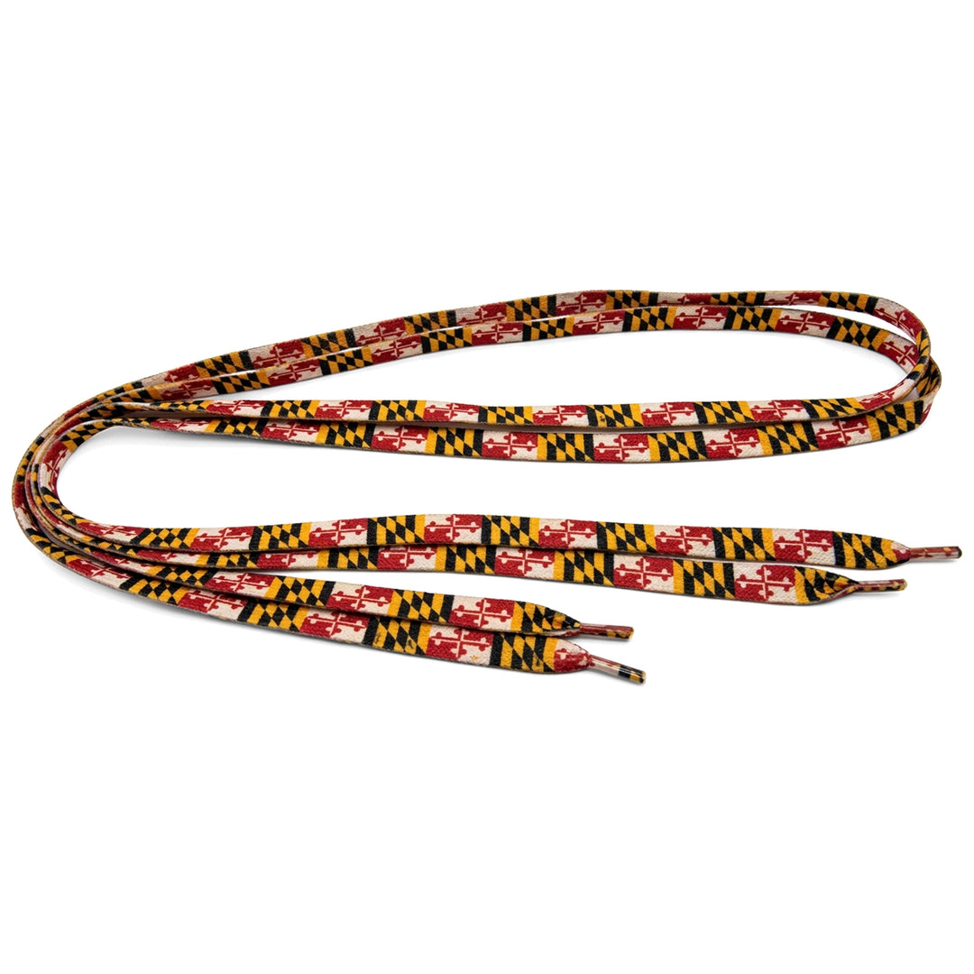A pair of shoelaces featuring a repeating Maryland state flag pattern in red, gold, black, and white.