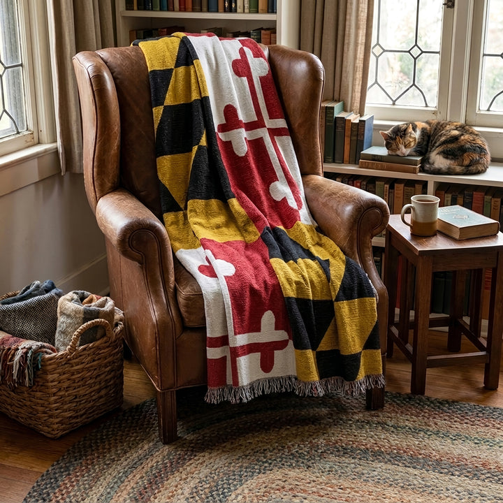 Maryland Flag Tapestry Throw Blanket across a cozy leather chair.