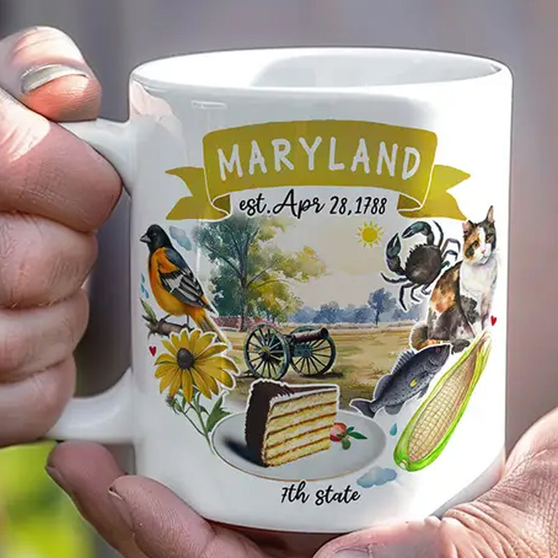 Mug with illustrations of Maryland symbols held by a hand
