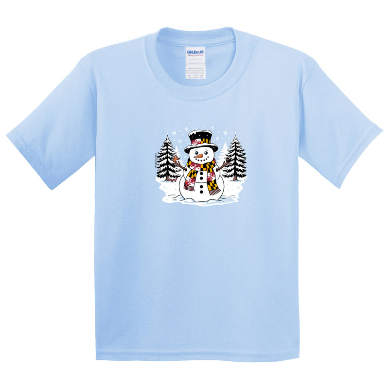 short sleeve t-shirt with front design of a snowman with Maryland Flag scarf and hat band with an oriole and raven on stick arms and a red crab under a pine tree with snow on the ground and trees