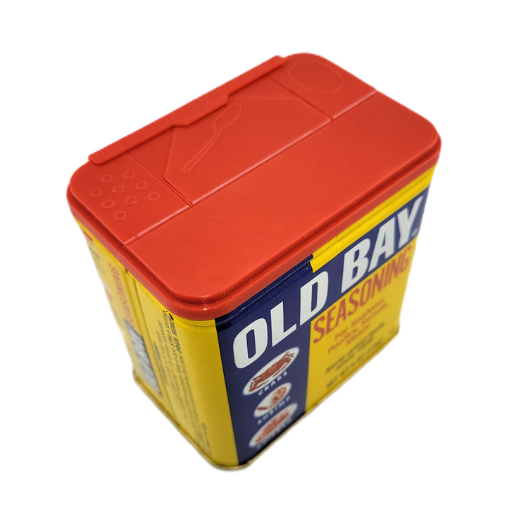 Old Bay seasoning container with red lid on a white background