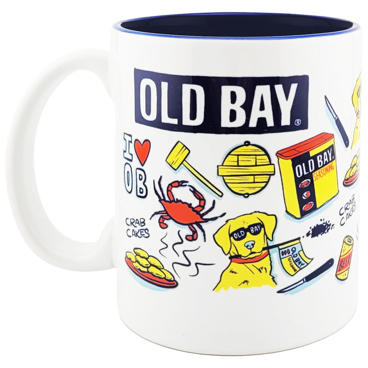 A white ceramic mug with a dark navy blue interior and handle, featuring a colorful &