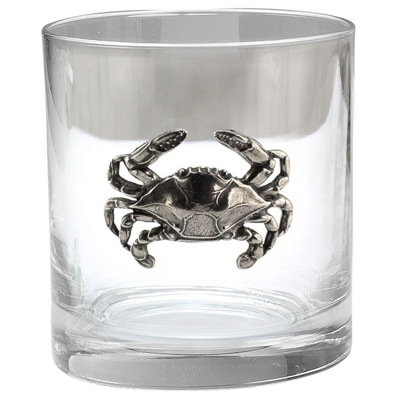 A clear glass rocks tumbler (old fashioned) featuring a detailed pewter crab medallion in the center.