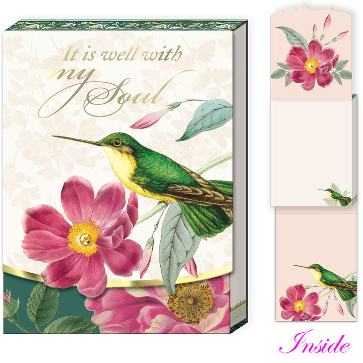 Decorative notepad with hummingbird and floral design, featuring text &