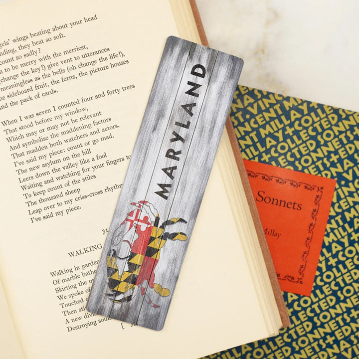 Maryland Rustic Crab Flag Metal Bookmark scene with books.