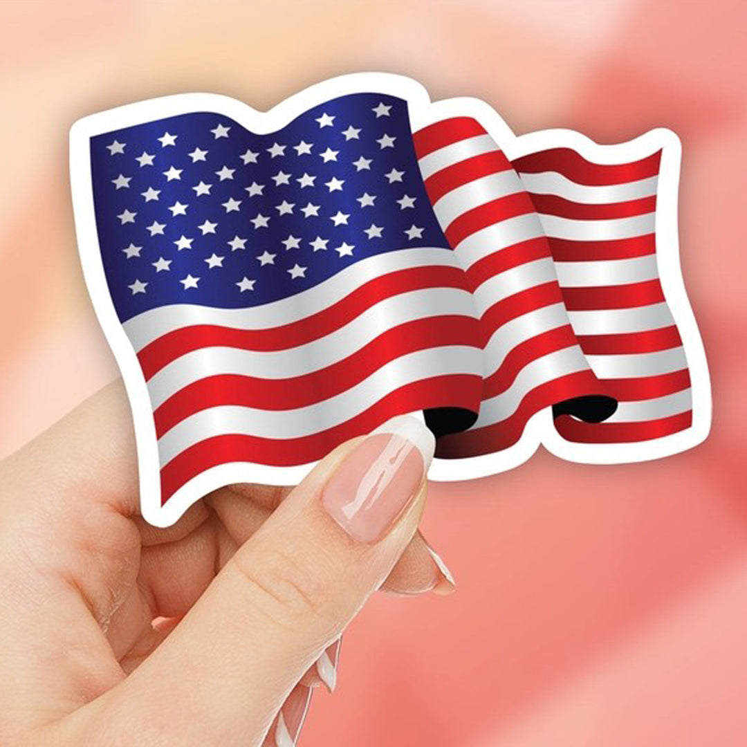 Waving American Flag Die Cut Vinyl Sticker being held by a hand.