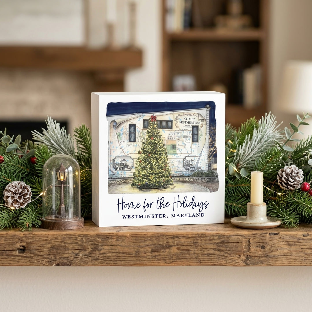 Westminster Maryland Home For The Holidays 5" Box Sign on a shelf decorated for Christmas.