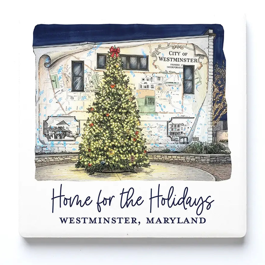 A square ceramic drink coaster featuring a printed illustration of a Christmas tree in front of a building in Westminster, Maryland, with the text &