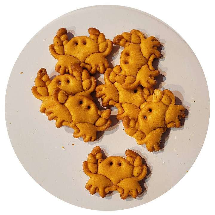 Wye River Crabbers Baked Gourmet Cheddar Cheese Snack &amp; Soup Crackers arranged on a round white plate against a white background.